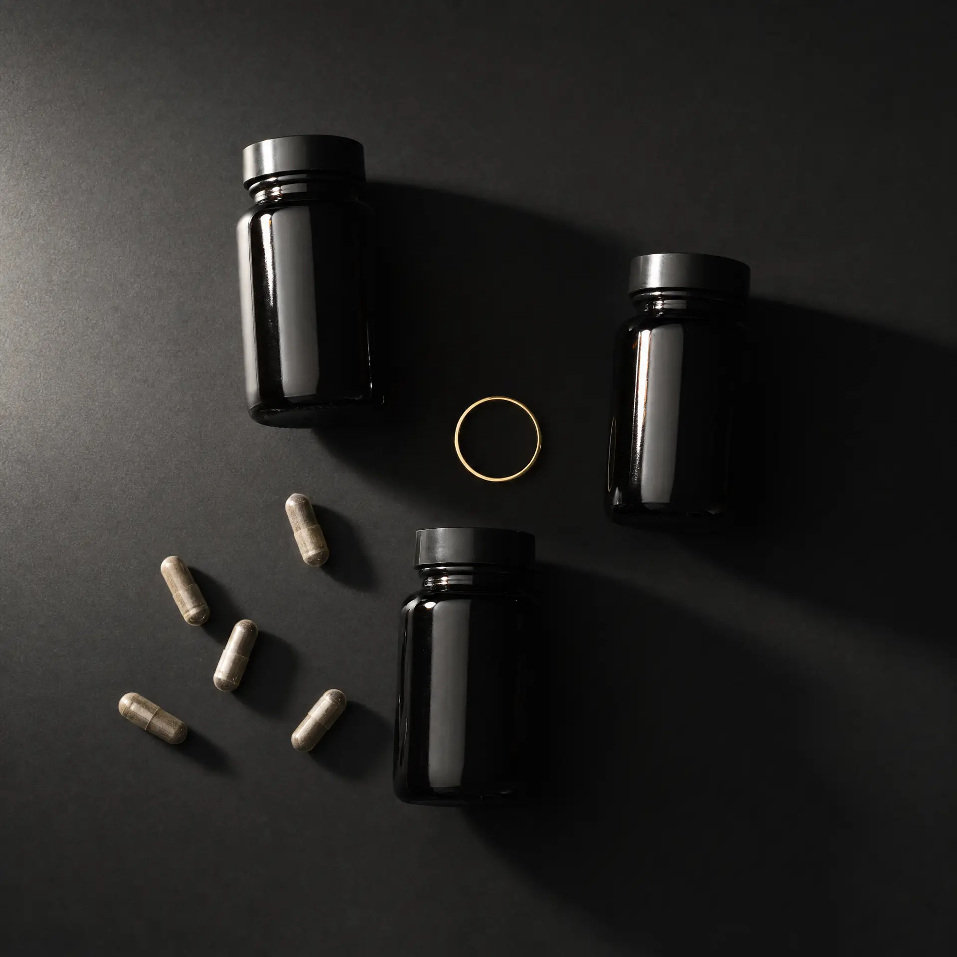sleep and recovery for men – magnesium zinc omega-3 supplement hierarchy on obsidian surface