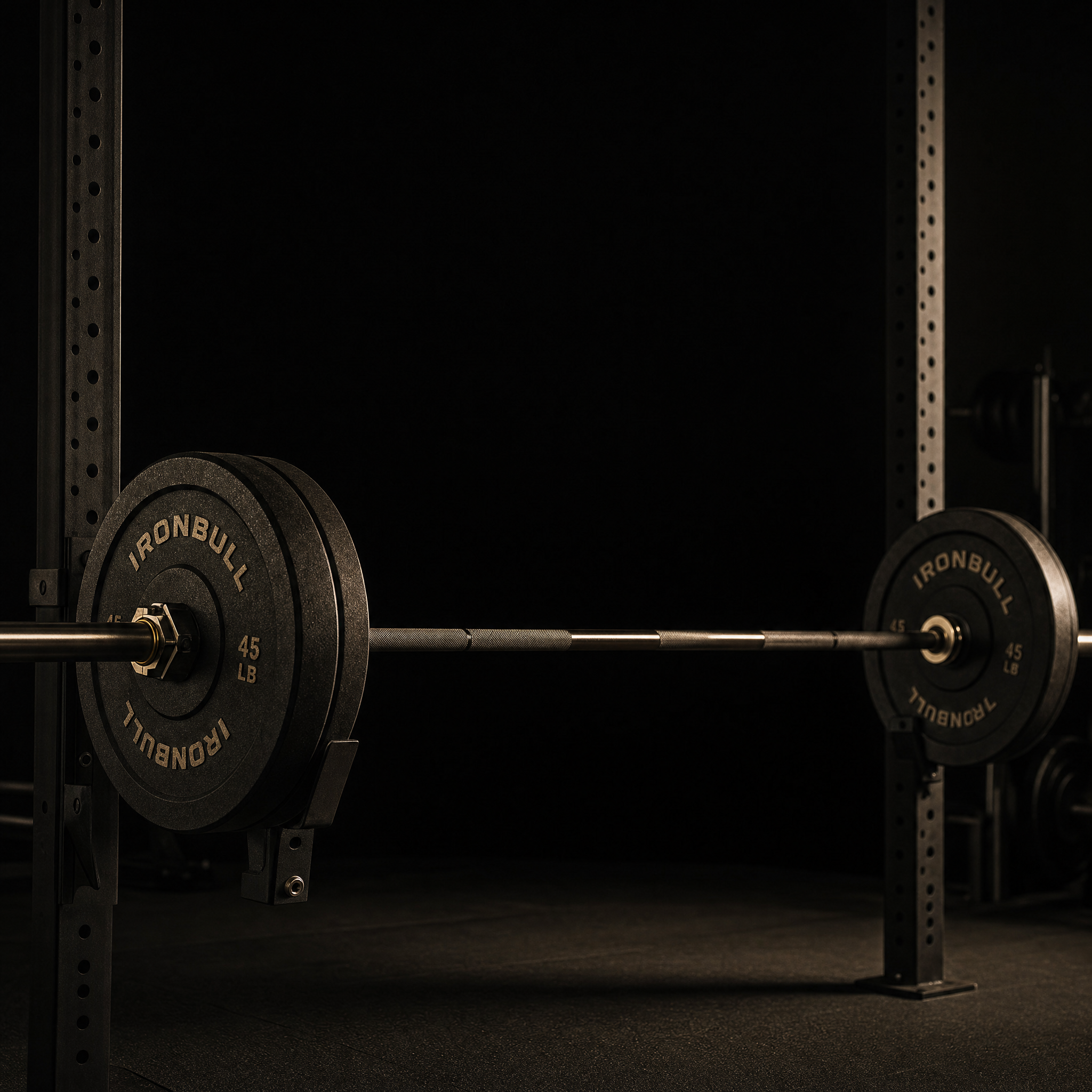 strength training for men over 30 – barbell loaded on squat rack in dark gym