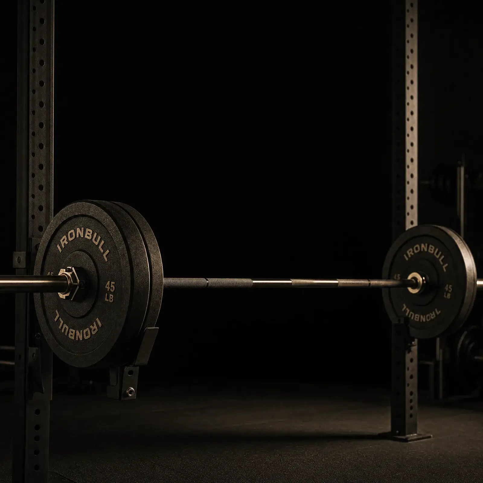 strength training for men over 30 – barbell loaded on squat rack in dark gym